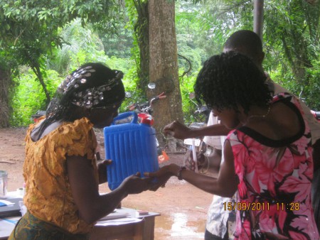 Participants demonstrating a Tippy Tap handwashing station in a NIWA activity